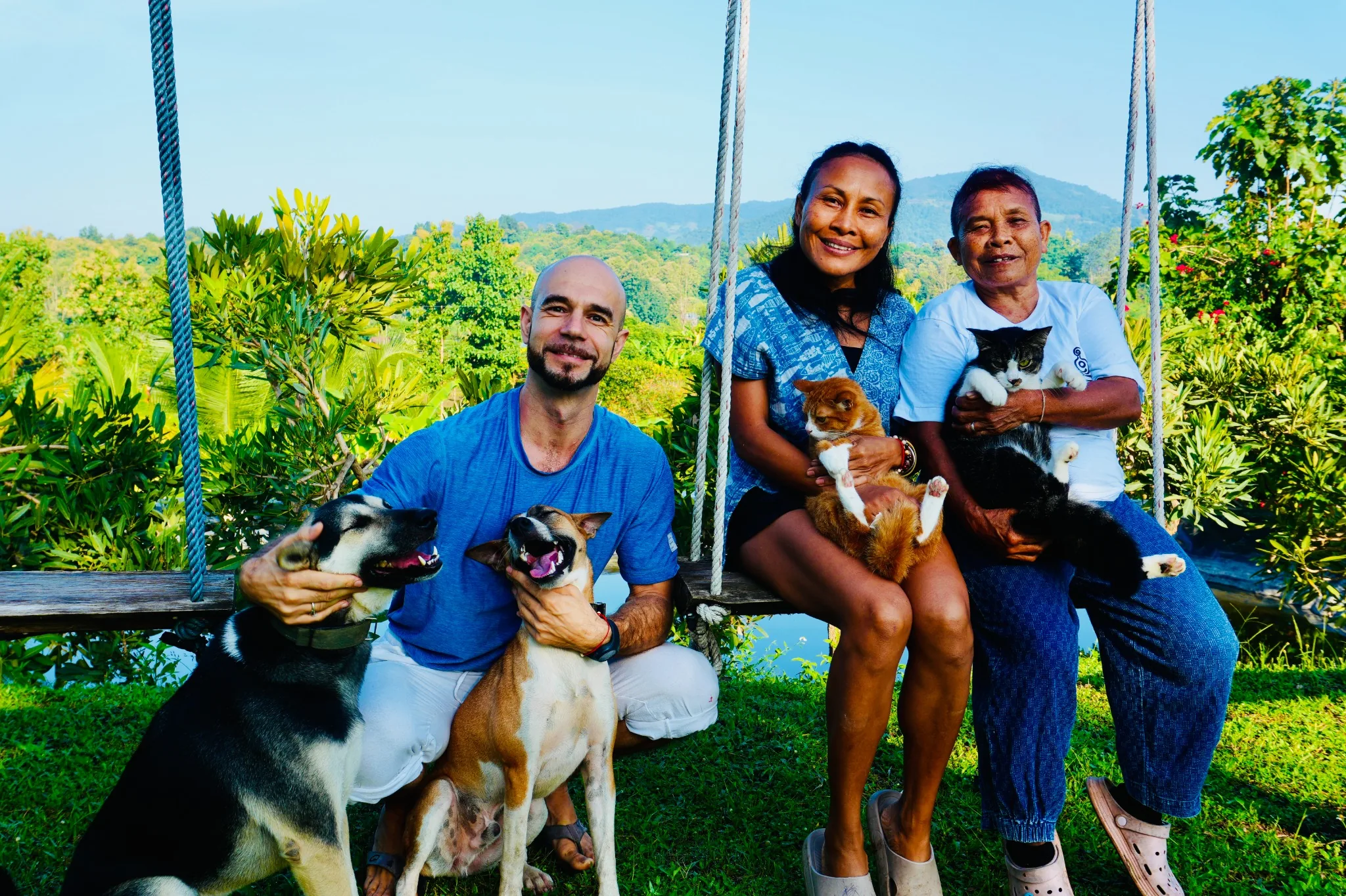 Adam, Ning and Yai together in the True Nature garden with the dogs and cats