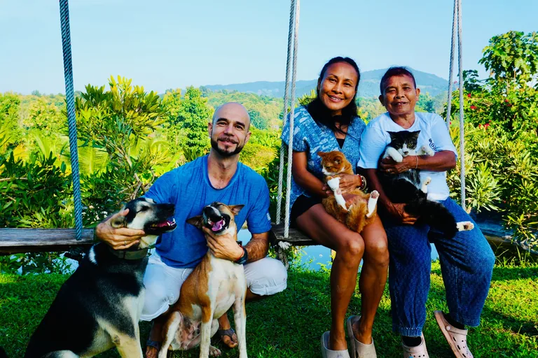 Adam, Ning and Yai together in the True Nature garden with the dogs and cats