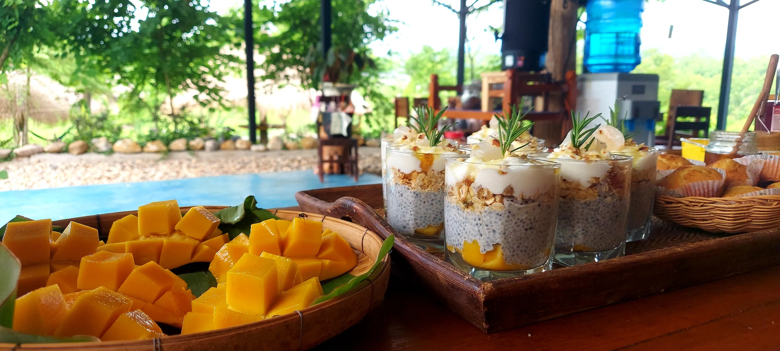 Fresh mango and chia breakfast glasses in the open-air dining area