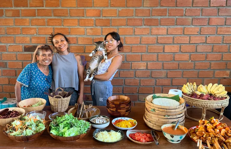Ning and her family beside a colourful buffet of home-cooked vegetarian food