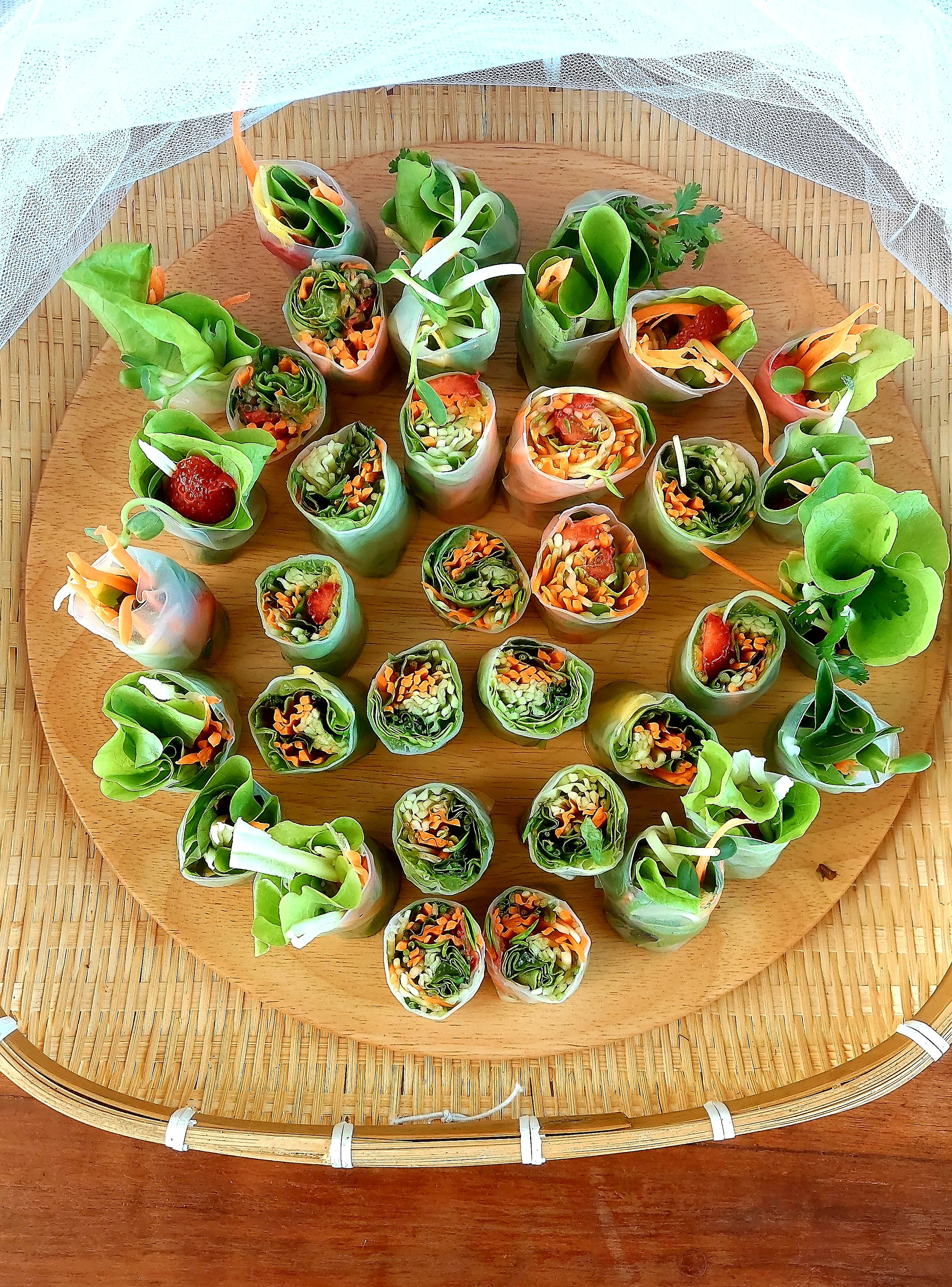Fresh vegetarian spring rolls served with vegetables and dipping sauces