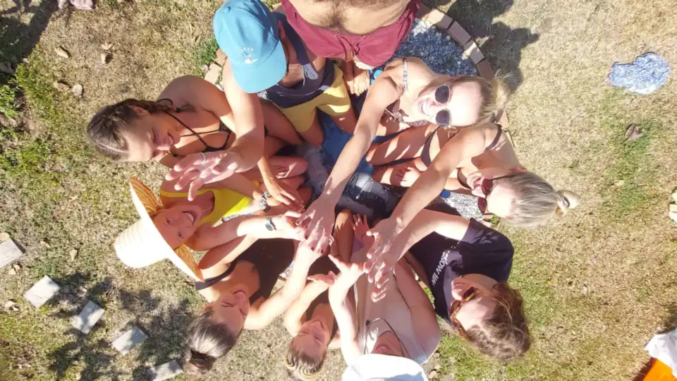 Guests putting their hands together in a circle, seen from above