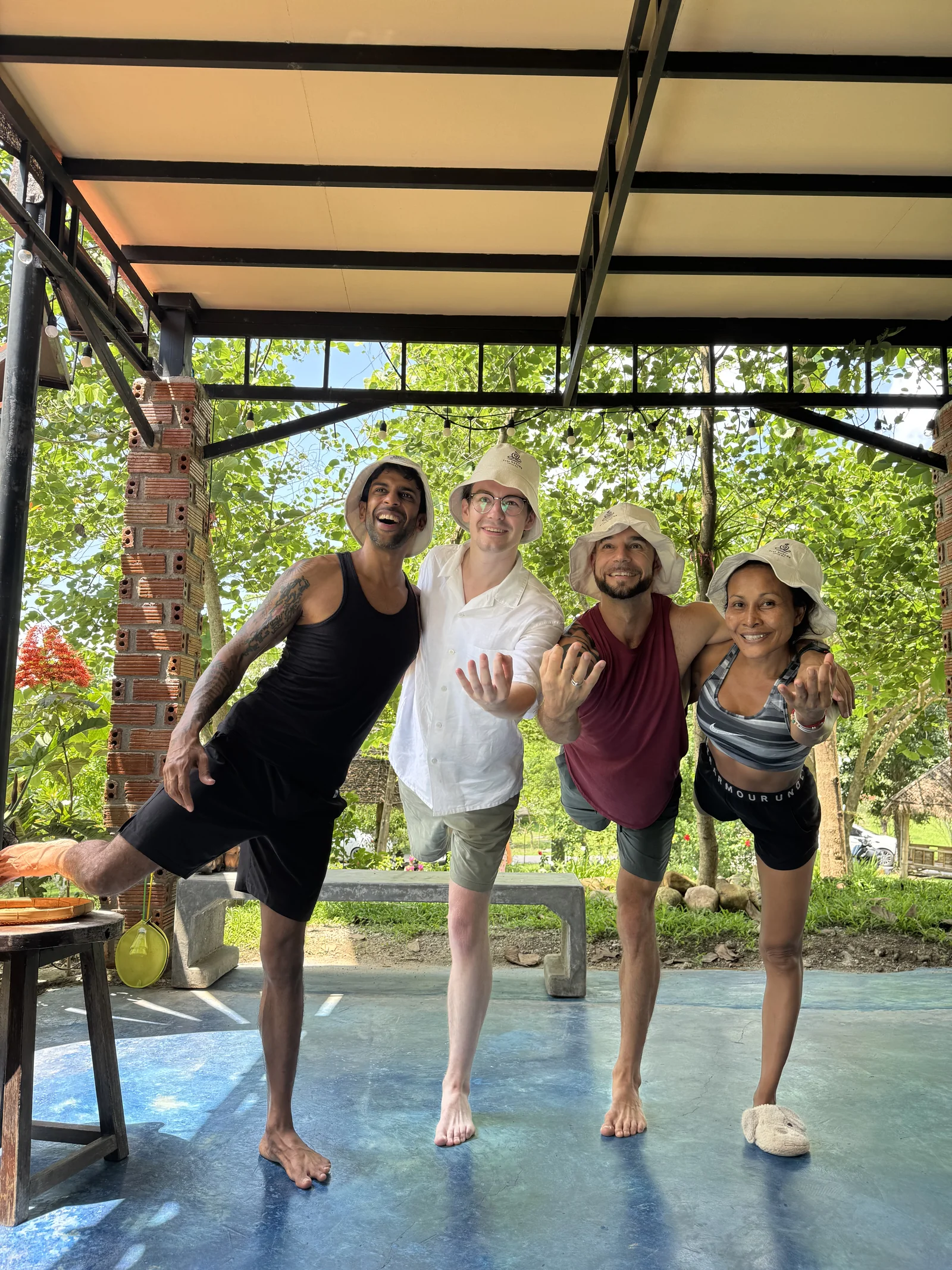 Guests sharing a playful balance pose together in the garden