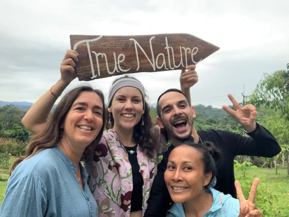 Guests from different countries smiling by the True Nature sign