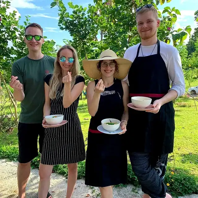A cooking class group showing off their dishes