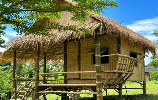 A thatched bamboo bungalow on stilts