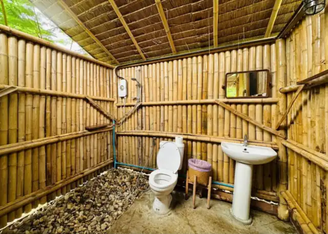The bamboo-walled private bathroom of a bungalow
