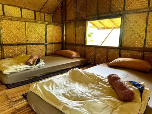 Inside a bamboo bungalow with two mattresses