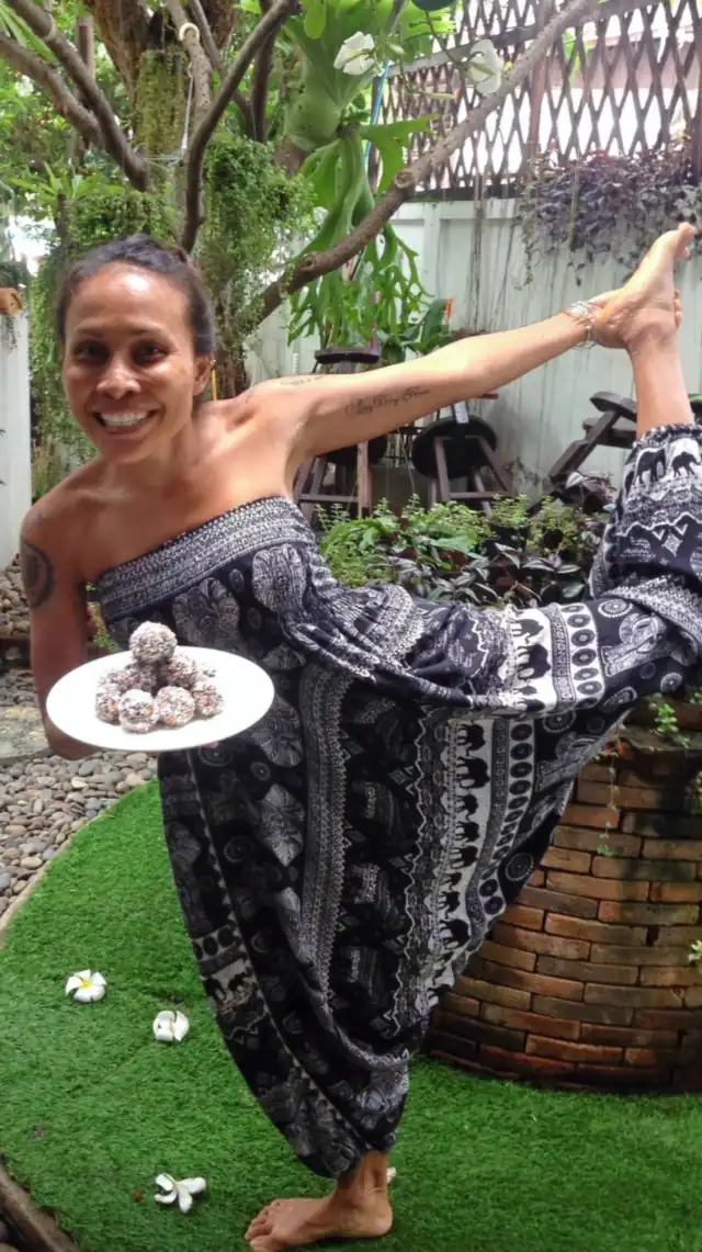 Ning in a standing balance holding a plate