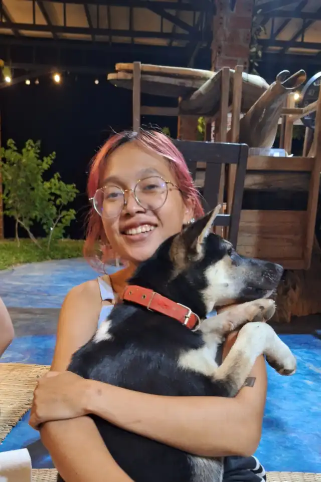 YuYe hugging one of the dogs