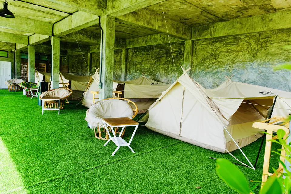 Canvas Mountain Tents and wicker chairs on the sheltered platform below the shala