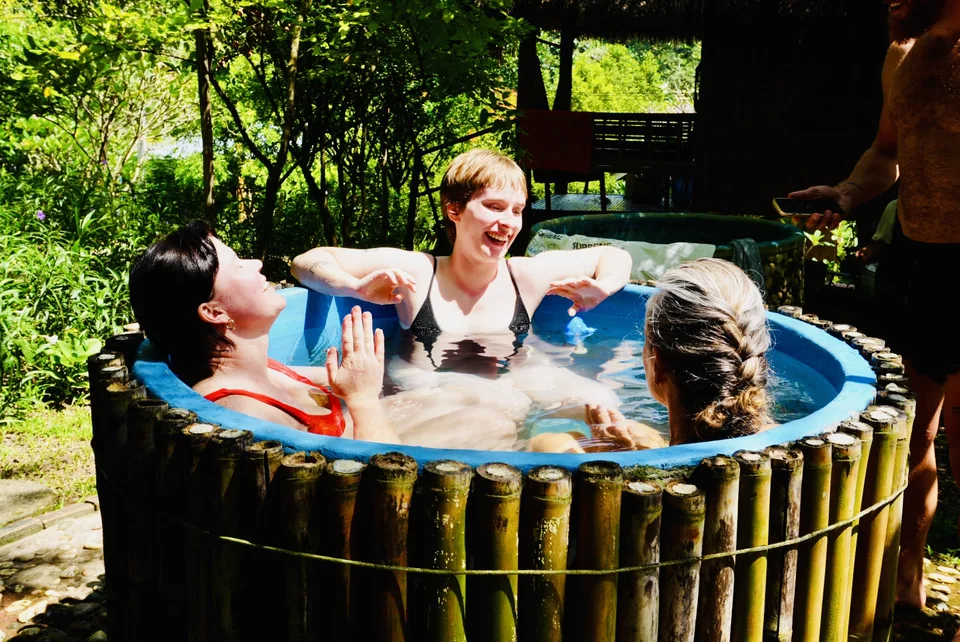 Guests laughing together in the bamboo ice bath at True Nature