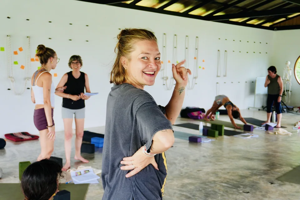 A teacher training student smiling between practical lessons in the True Nature shala