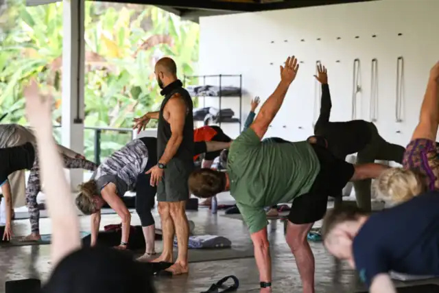 Students flowing through a yoga sequence