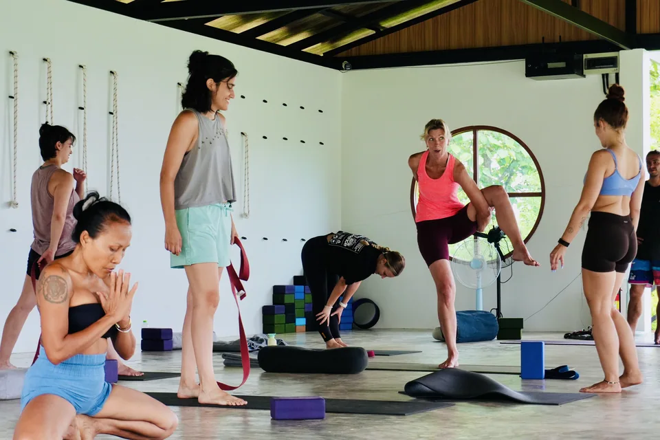 Guests listening to guidance during yoga practice