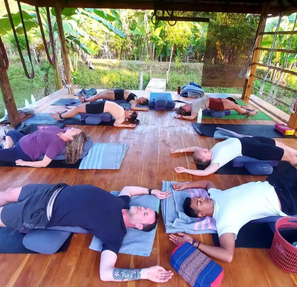 Guests resting on bolsters in a gentle True Nature yoga practice