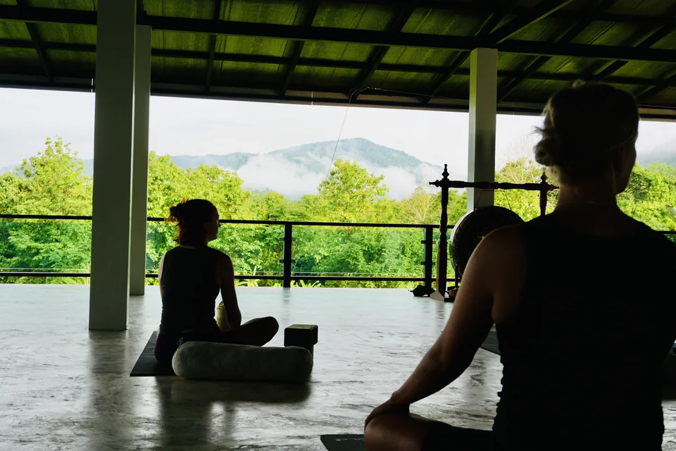 Guests sitting quietly with views over the green hillside