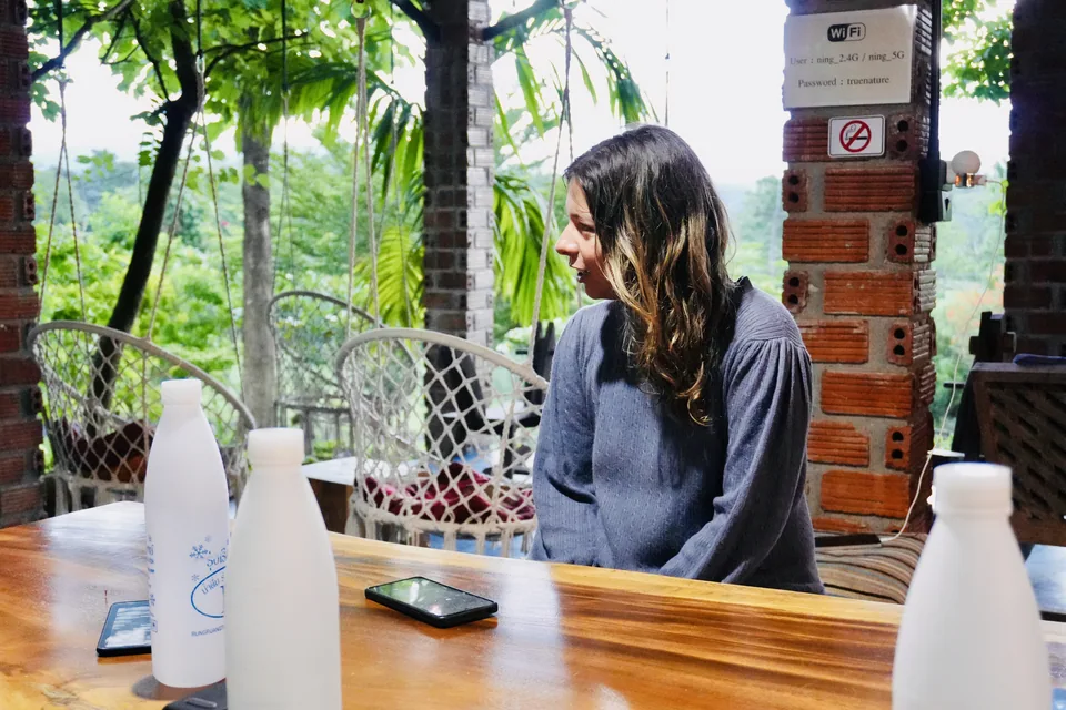 A guest enjoying a quiet moment in the open-air dining area