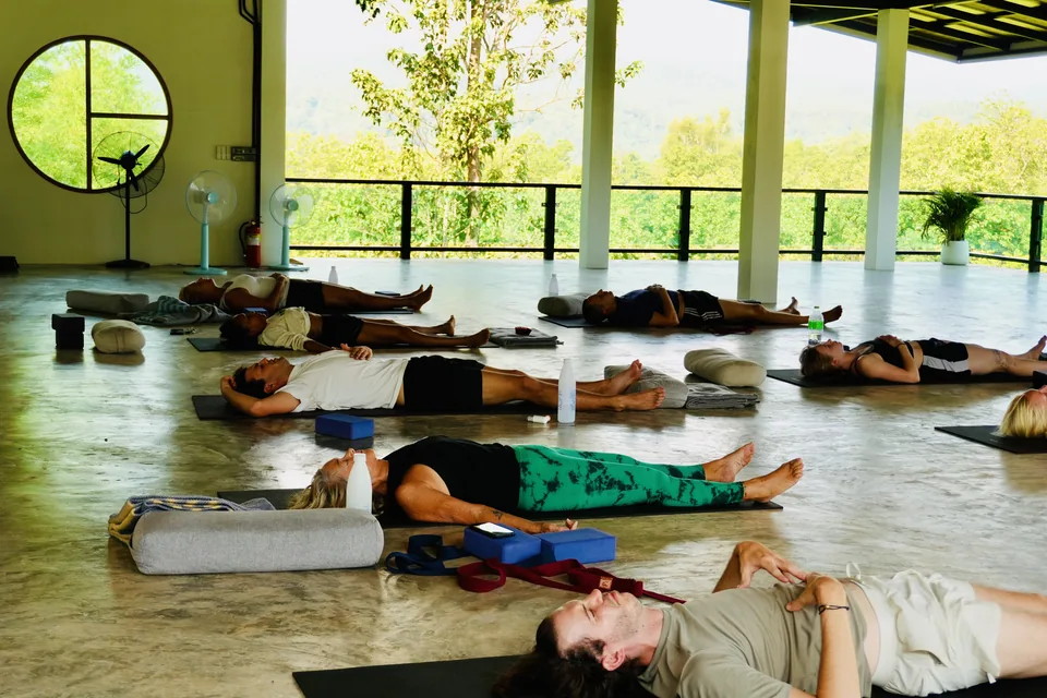 Guests resting in the open-air shala after practice