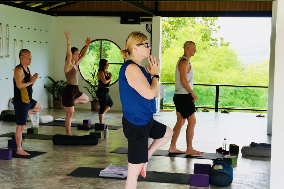 A standing balance practice in the bright True Nature shala